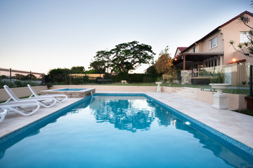 Modern swimming pool water close up beside the chairs