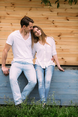 couple posing on a background of the wooden wall