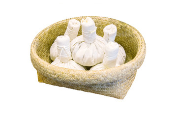 herbal compress for spa treatment in wicker baskets isolated whi