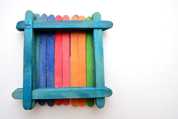 Colorful popsicle sticks over white background