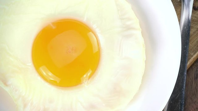 Fried Eggs (rotating, close-up) as seamless loopable 4K UHD footage