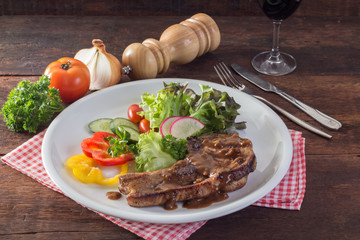 Kurobuta pork chop steak and vegetable on wooden table
