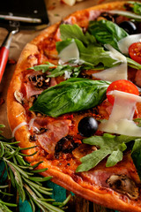 Close up of Homemade delicious pizza with bacon, tomatoes, olive