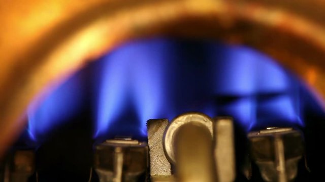Geyser, water heater. The flame of a torch burns and dies away