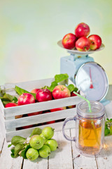 fresh juice and red apples in wooden box