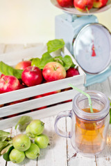 fresh juice and red apples in wooden box