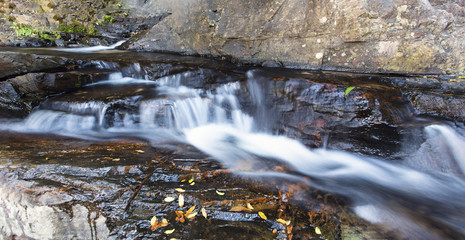 Fototapeta na wymiar Small waterfall landscape with long exposure in river