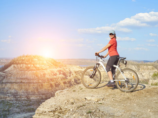 Fototapeta premium Girl a bike in mountains.