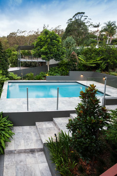 Floor tile way through the garden to a swimming pool