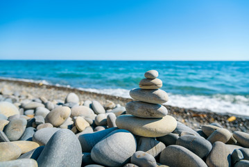 Meditation with the stone tower on the sea shore