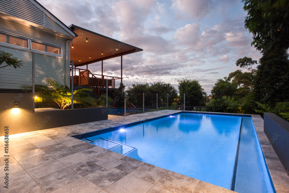 Wall mural House with a pool at evening or in the morning