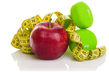 Two dumbbells, red apple, measuring tape.