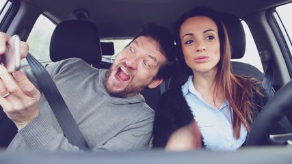 Couple driving car taking selfie almost getting into accident