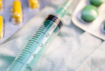 Syringe and pills on the dressing in a hospital