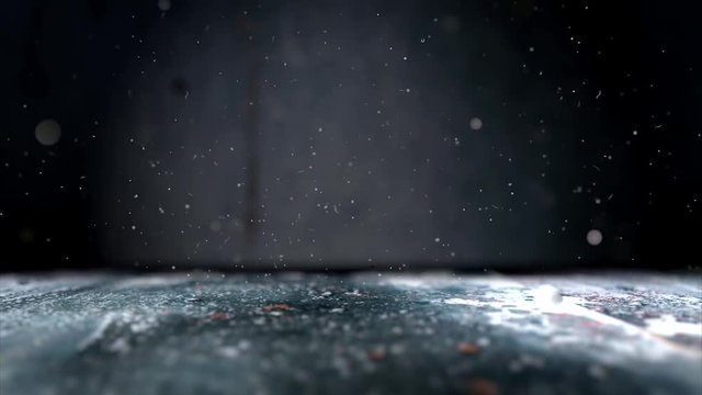 Fondo abstracto suelo de hormigon y pared de cemento.Polvo y brillantina flotando en la oscuridad.Luz de foco y desenfoque