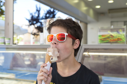 Teenage boy eating ice cream