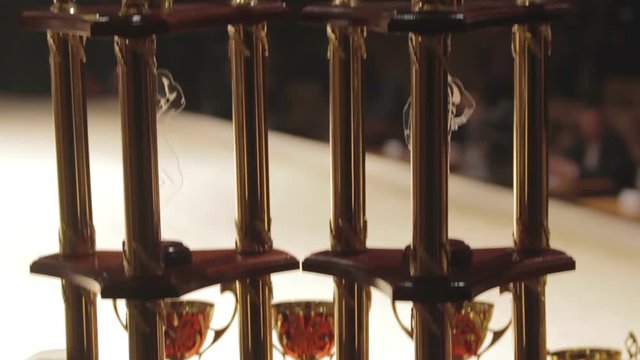 Golden grand prix cups for successful sports contest winners, competitive spirit
