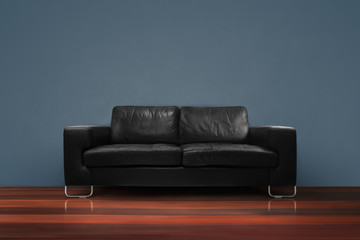 Fototapeta na wymiar black sofa with wooden floor dark green concrete wall in empty living room interior