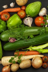 Various types of vegetables on an old wooden table. Sales of fresh vegetables. Dietary supplements for athletes.
