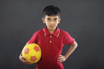 Foto op Canvas Indian boy holding football © V.R.Murralinath