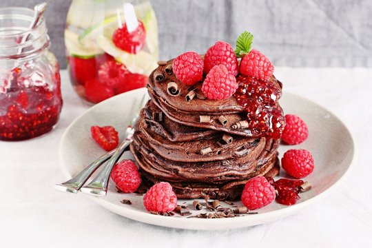 Chocolate pancakes with fresh raspberries. Selective focus
