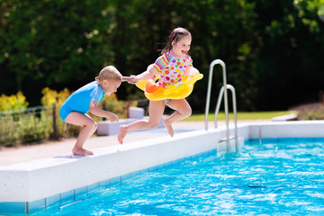 Kids jumping into swimming pool