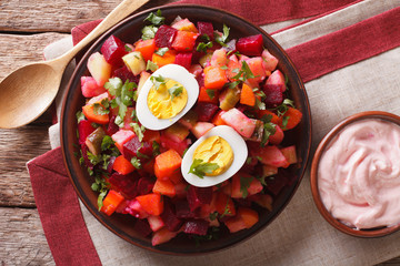 Finnish rosolli vegetable salad and sauce close-up. horizontal top view
