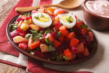 Finnish cuisine: rosolli salad and cream sauce close-up. horizontal
