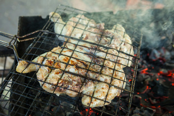 Roast chicken on grill. Fried chicken on the barbecue grill cooked on the coals. Chicken tobacco or chicken tapaka. Georgian cuisine