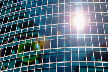 Fototapeta na wymiar Abstract view - skyscraper windows and solar flare
