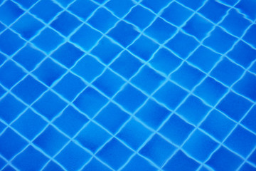 Fototapeta na wymiar Bottom of swimming pool covered with tiles