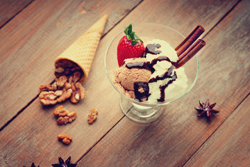 Ice cream sundae, waffle cone, walnuts and strawberry