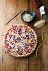 Delicious pizza with salami, tomatoes