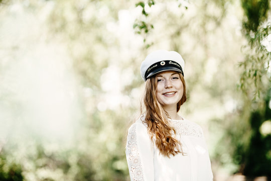 Portrait of happy graduate at university park