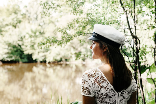 Rear view of thoughtful female graduate at university park