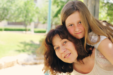 Outdoor portrait of mother and daughter