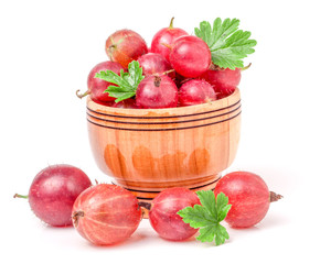 red gooseberries with leaf in wooden bowl isolated on white