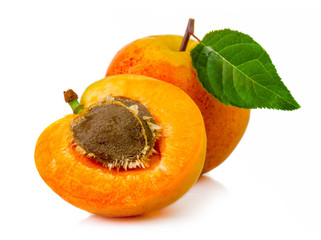 Ripe apricot fruits with green leaves isolated