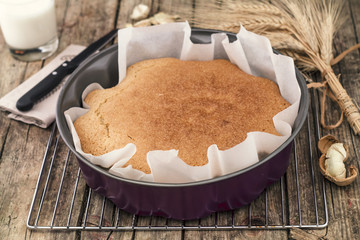 Yogurt cake and coconut in a pan of steel. 