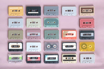 Cassette tapes / Set of retro cassette tapes on pink background. Top view. Flat lay.