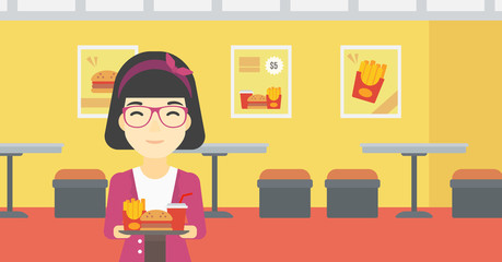 Woman with tray full of fast food.