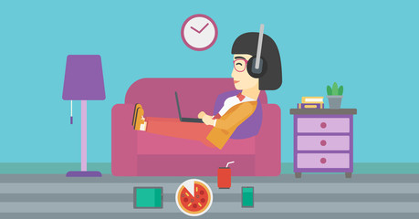 Woman lying on sofa with many gadgets.