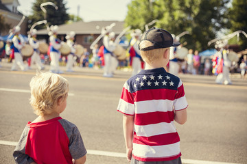 Kids watching an Independence Day Parade on a Summer Day