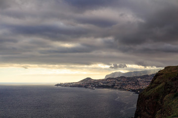 Funchal coastline under the typical cloudy sky before sunset.