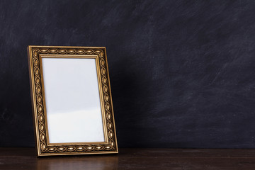 Picture frame against a dirty blackboard background