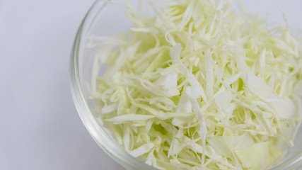 Cabbage cut into small in a white ceramic cup