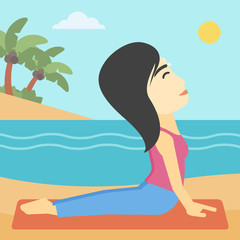 Obraz na płótnie Canvas Woman practicing yoga upward dog pose on beach.