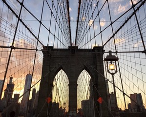 silhouette of Brooklyn bridge and building with sunset sky between Manhattan and Brooklyn