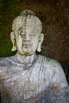 Old stone Buddha statue. Indonesia, Bali.