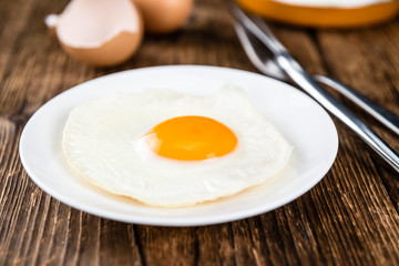 Wooden table with Fried Eggs (selective focus)